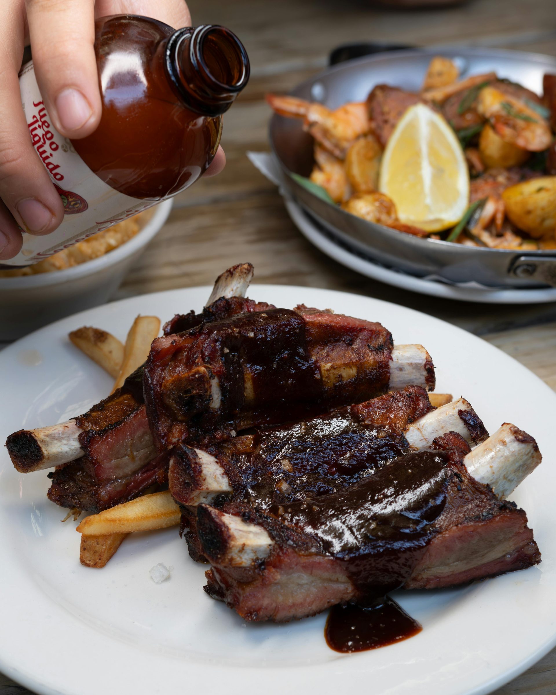 Savor these juicy barbecue ribs drenched in sauce, perfect for a delightful meal.